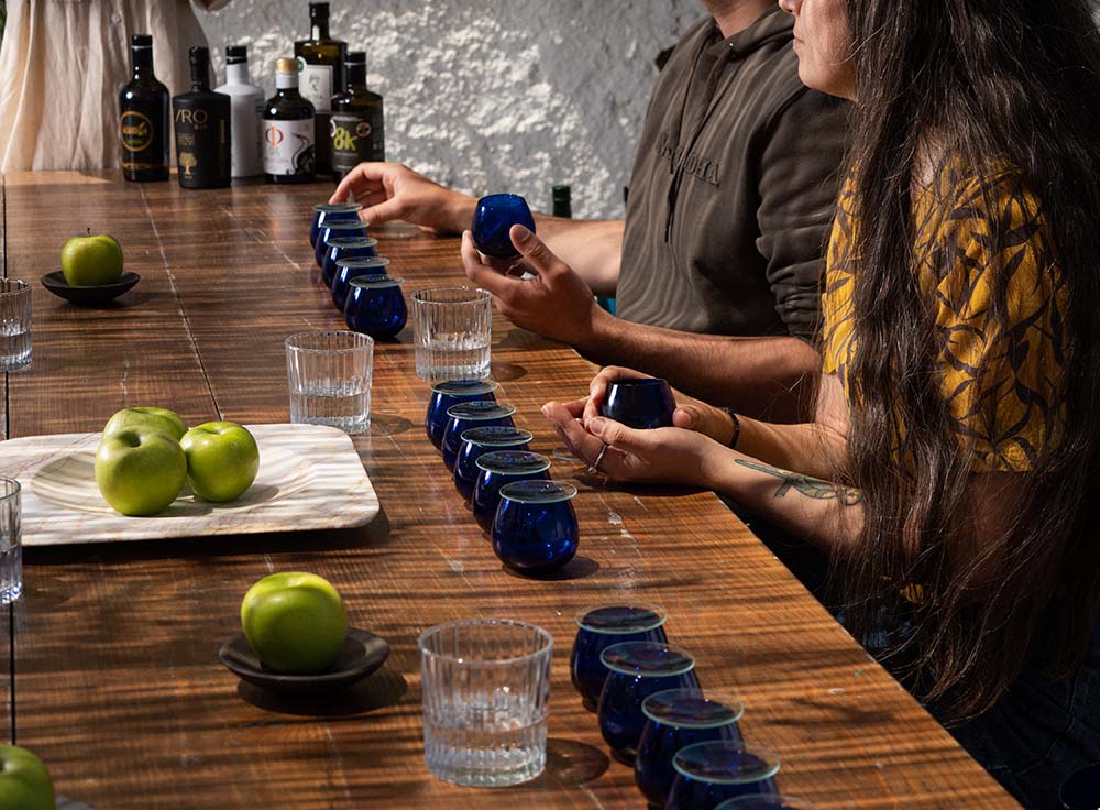 This photograph shows a photo that depicting the olive oil tasting procedure during the olive oil tasting experience in Santorini